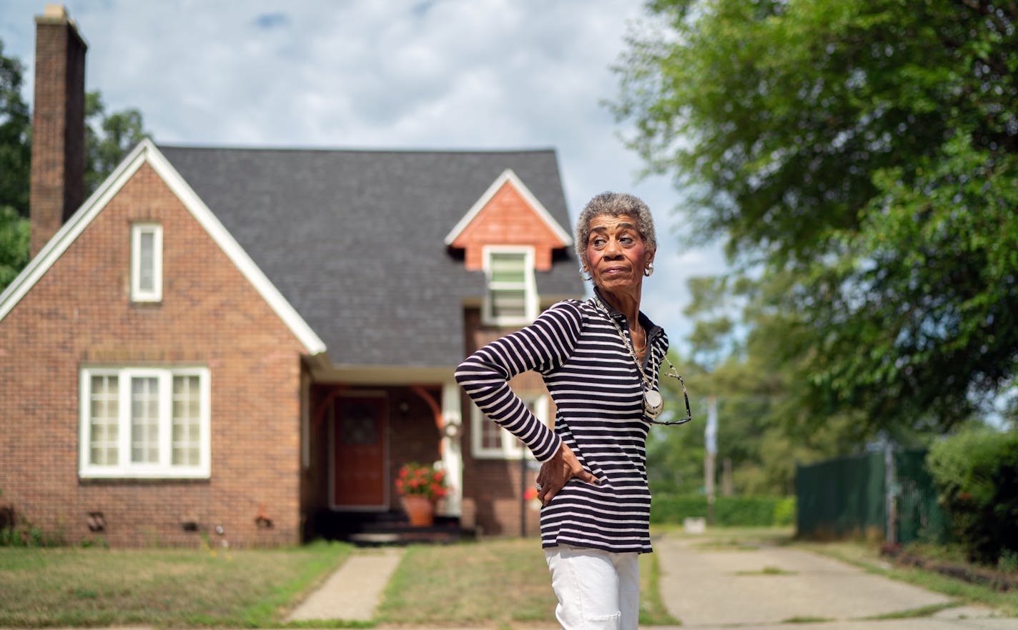 Muskegon County Commissioner Rillastine Wilkins in front of her Muskegon Heights home. Someone threw a brick through her front window when she moved in to the formerly all white neighborhood.