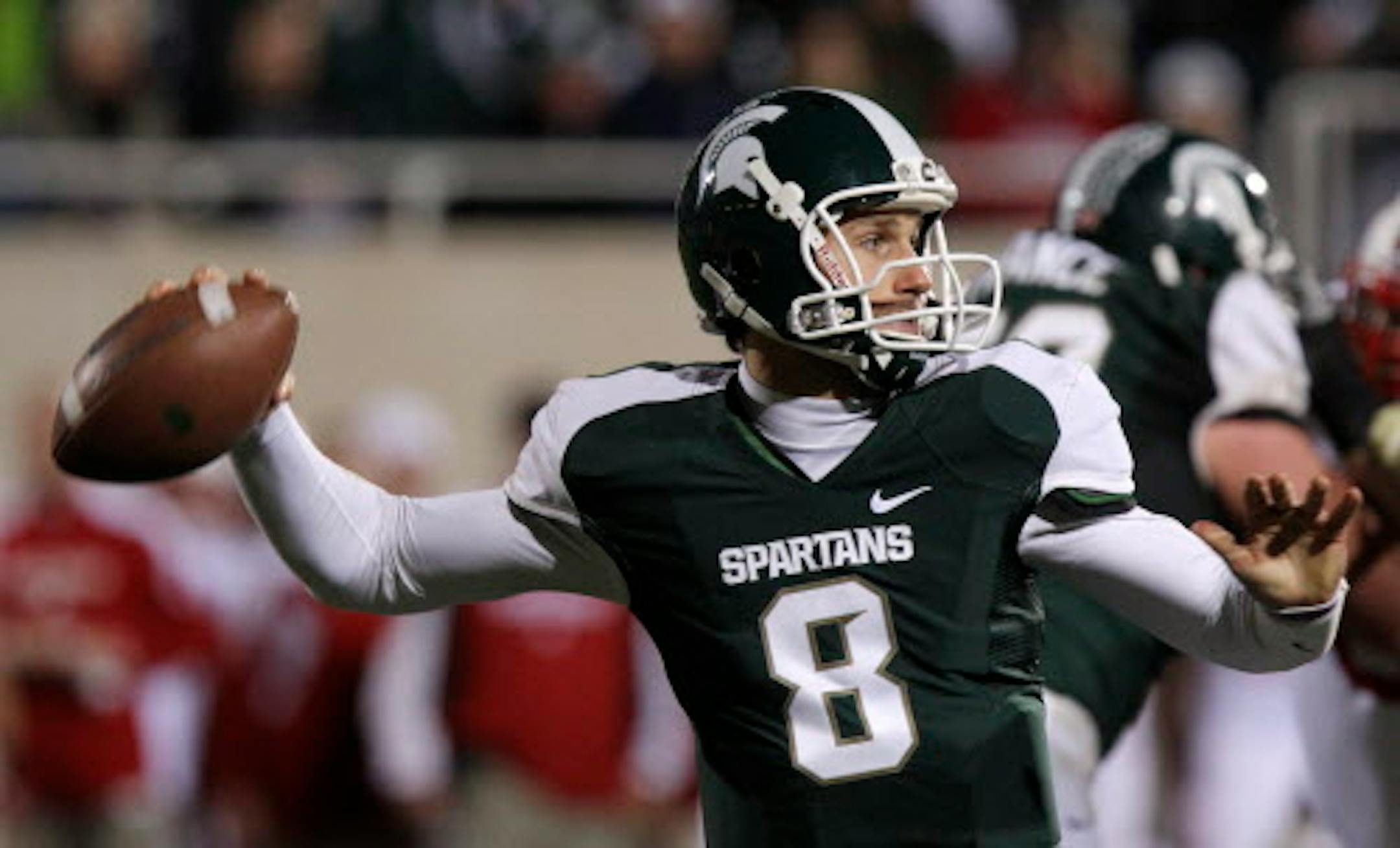 Michigan State quarterback Kirk Cousins throws during the fourth quarter of an NCAA college football game against Wisconsin in East Lansing, Mich., Saturday, Oct. 22, 2011. With the game tied with 4 seconds left, Cousins threw a 44-yard Hail Mary to win the game. (AP Photo/Carlos Osorio)