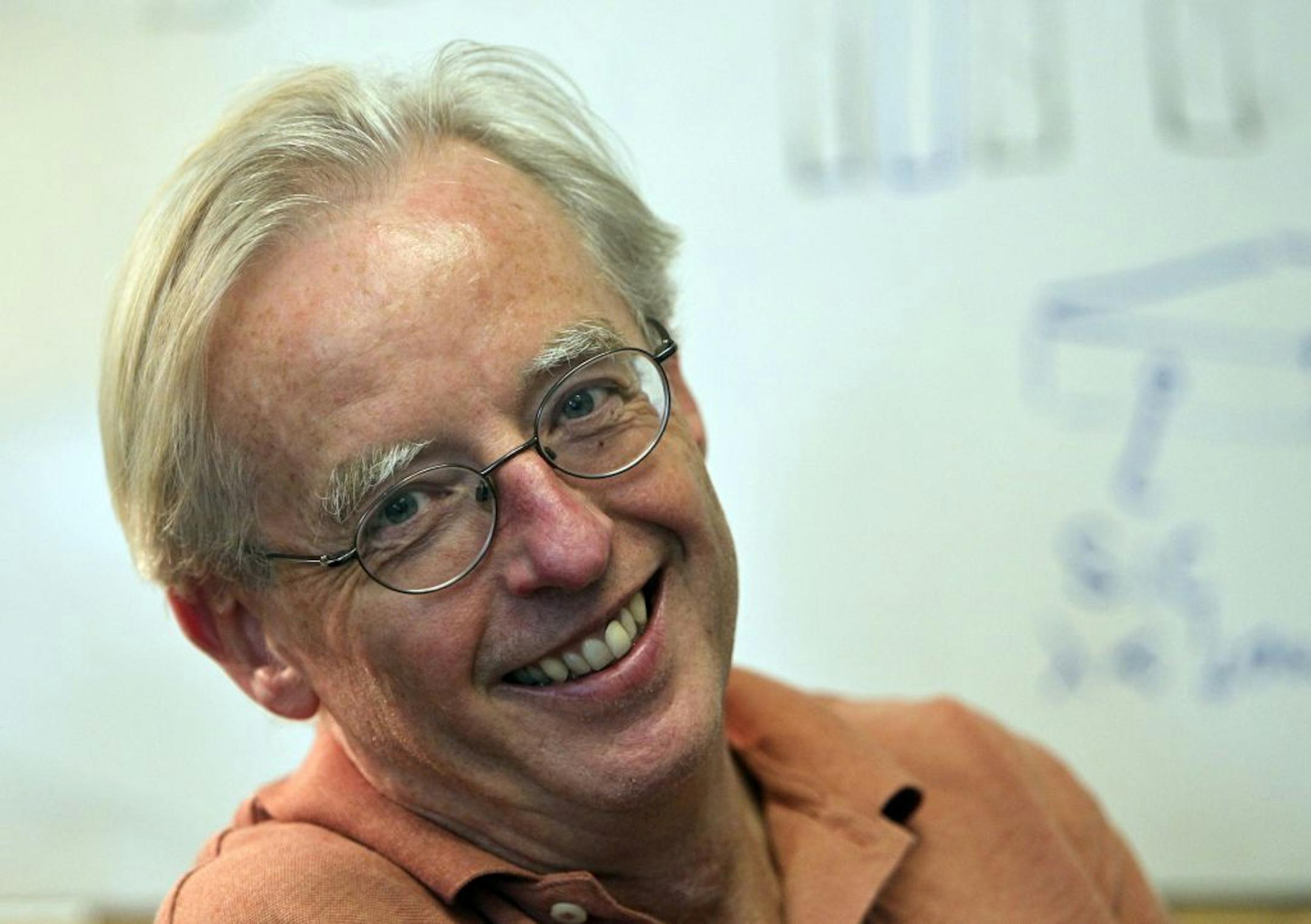 Roger Rusack, physics professor, School of Physics and Astronomy at the University of Minnesota, posed in his office near a white board drawing of the next stage in the devlopment of an electromagnetic Calorimeter (ECAL). ECAL measures the energies of photons produced in the collisions – a key way of searching for the Higgs boson. Rusack was photographed Friday, July 6, 2012, in Minneapolis, MN.
