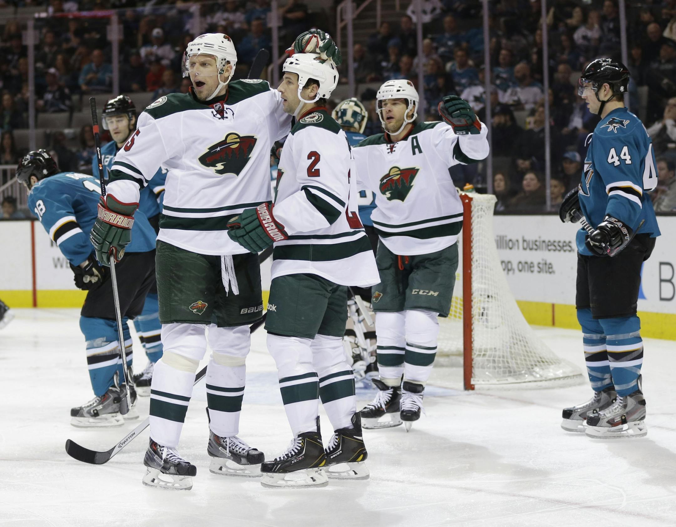 Minnesota Wild's Keith Ballard (2) celebrates his goal with teammate Dany Heatley (15) during the second period of an NHL hockey game against the San Jose Sharks on Saturday, Jan. 25, 2014, in San Jose, Calif.