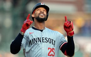 Twins center fielder Byron Buxton approaches home plate after hitting a home run during the first inning Friday in Detroit. Trevor Larnach followed ri