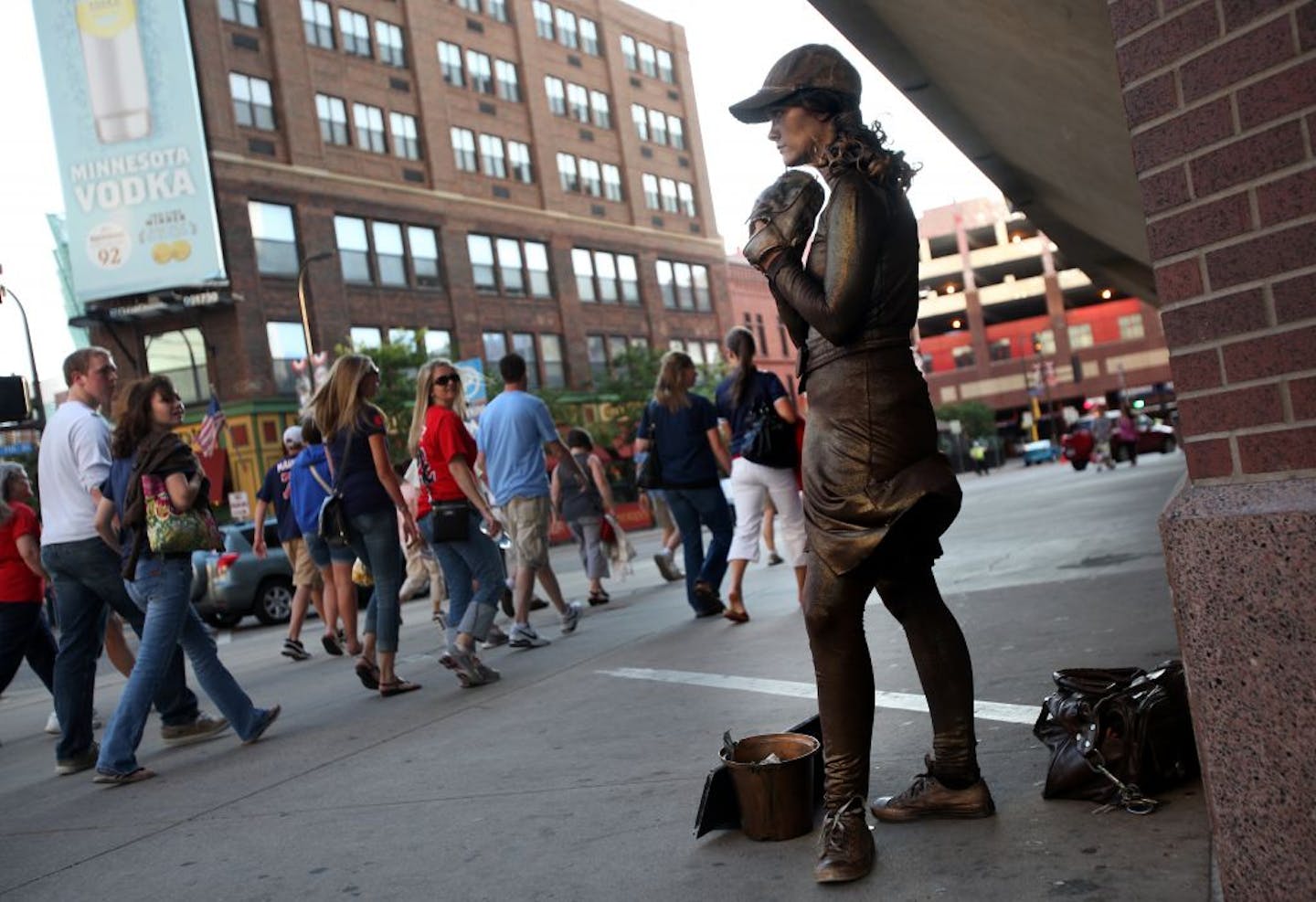 Passersby looked curiously at Sarah Steinman, who poses as a statue outside Twins games.