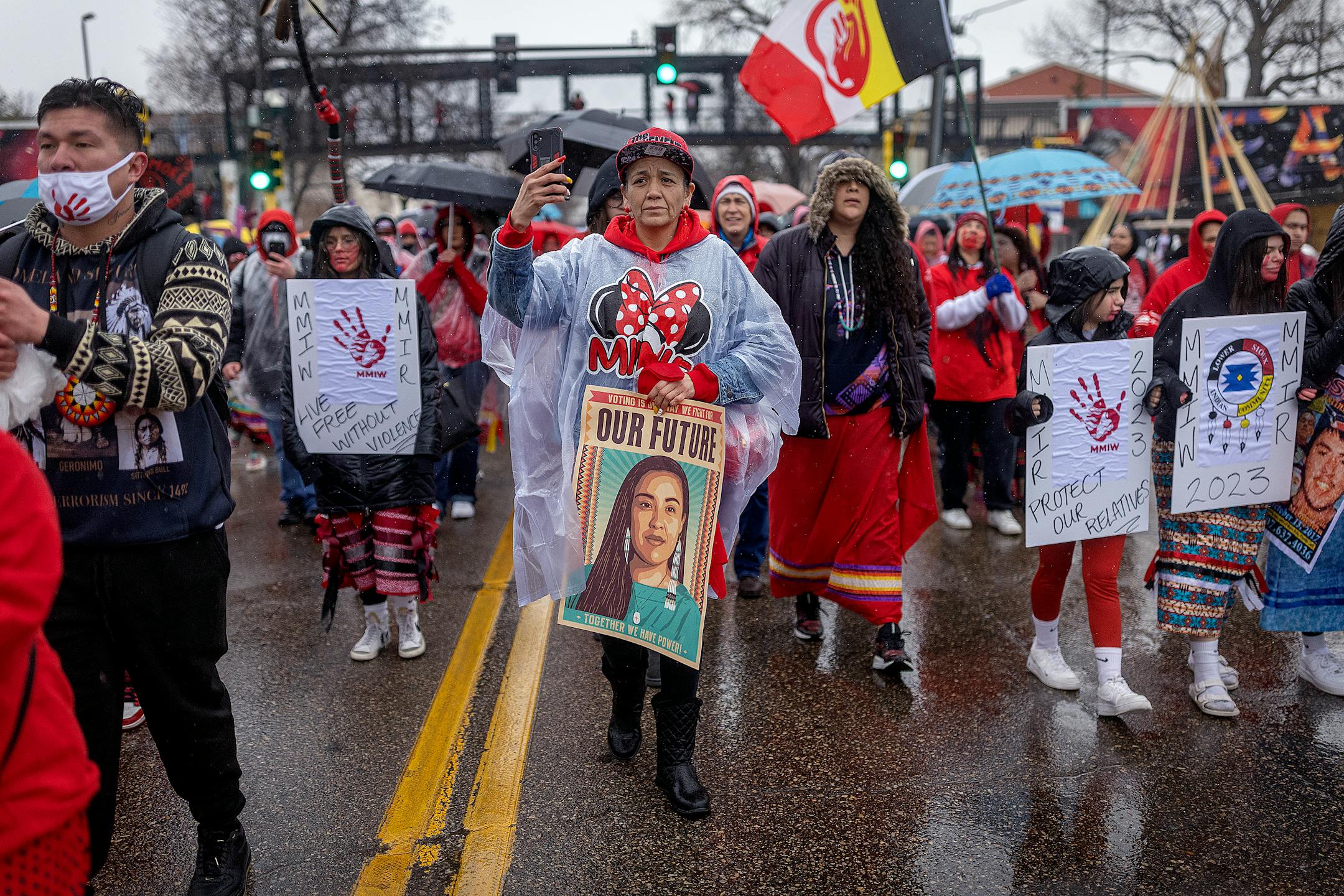 Hundreds march down Cedar Avenue near Little Earth during the annual Missing and Murdered Indigenous Women's rally and march at the East Phillips Park Cultural & Community Center, in Minneapolis, Minn., on Tuesday, Feb. 14, 2023.  Minnesota's movement to solve the cases of hundreds of missing and murdered Indigenous women and girls hit a milestone last year with the opening of a first-in-the-nation office tasked with systemically trying to fix the problem. Minnesota's Native women legislators reflected on where the movement goes from here during the annual Missing and Murdered Indigenous Women's march in Minneapolis.   ] Elizabeth Flores • liz.flores@startribune.com