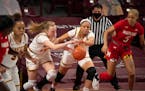 Gophers forward Laura Bagwell-Katalinich (12) and center Klarke Sconiers (25) both went for a loose ball against Maryland in a game earlier this seaso