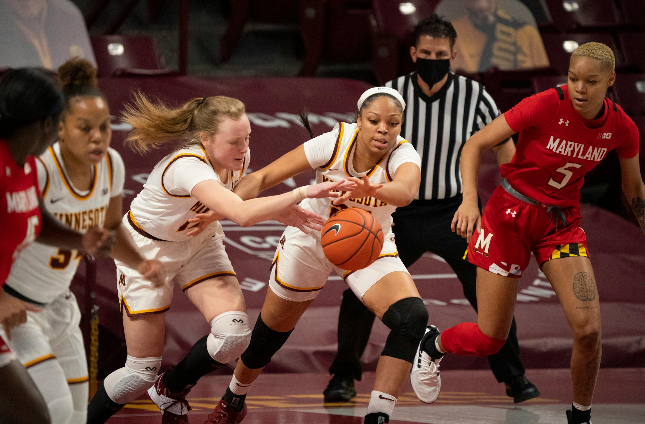 Gophers forward Laura Bagwell-Katalinich (12) and center Klarke Sconiers (25) both went for a loose ball against Maryland in a game earlier this season.