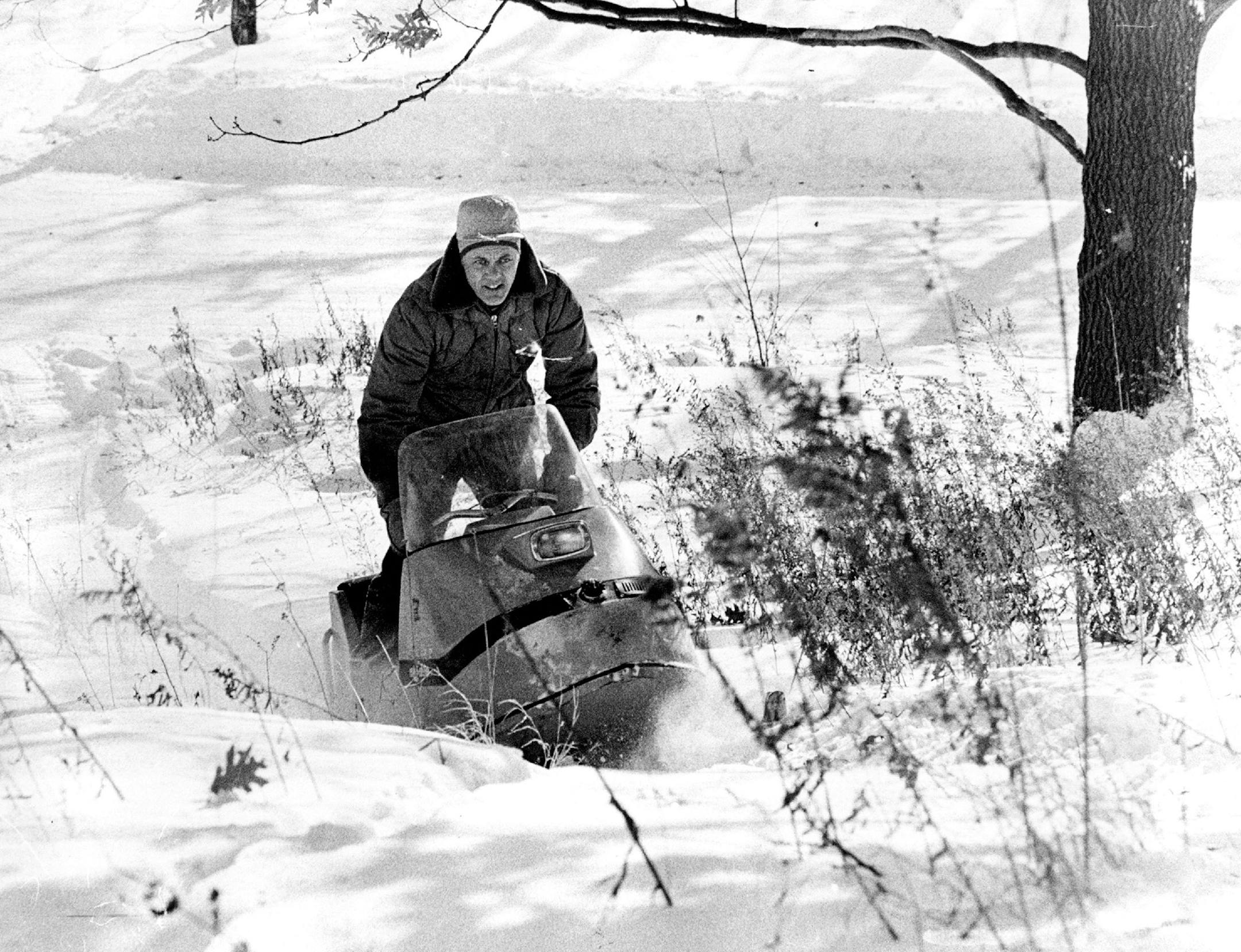 Bud Grant drives his snowmobile in the deep snow on February 6, 1971.
