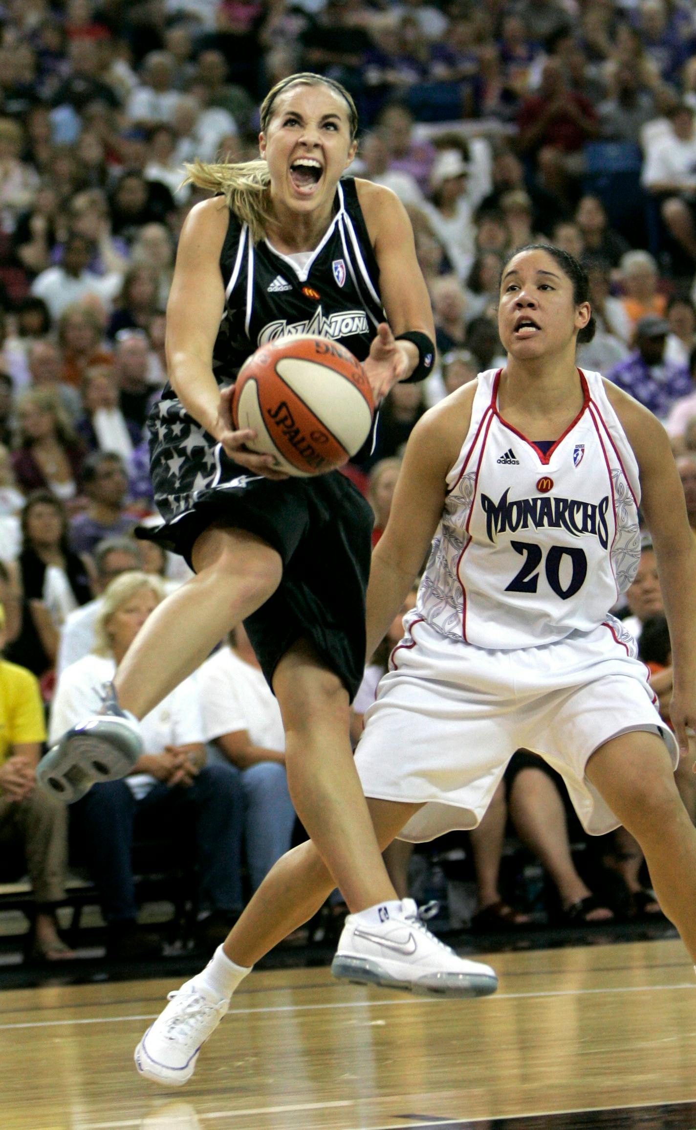 San Antonio Silver Stars guard Becky Hammon, left, drives to the basket past Sacramento Monarchs guard Kara Lawson during the second quarter of a WNBA basketball game in Sacramento, Calif., Saturday, May 17, 2008.