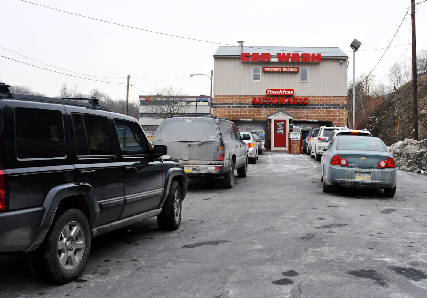 FILE - In this Jan. 31, 2014 file photo, cars line up for a car wash at the Washery System Touchless Automatic Car Wash on Terry Reiley Way in Pottsville, Pa. The National Highway Traffic Safety Administration on Wednesday, April 8, 2015 urged people in 20 cold-weather states and Washington, D.C., to get their car and truck undercarriages washed several times during and after the winter, and to get their brake lines inspected for rust and replace them if necessary. (AP Photo/Republican-Herald, J