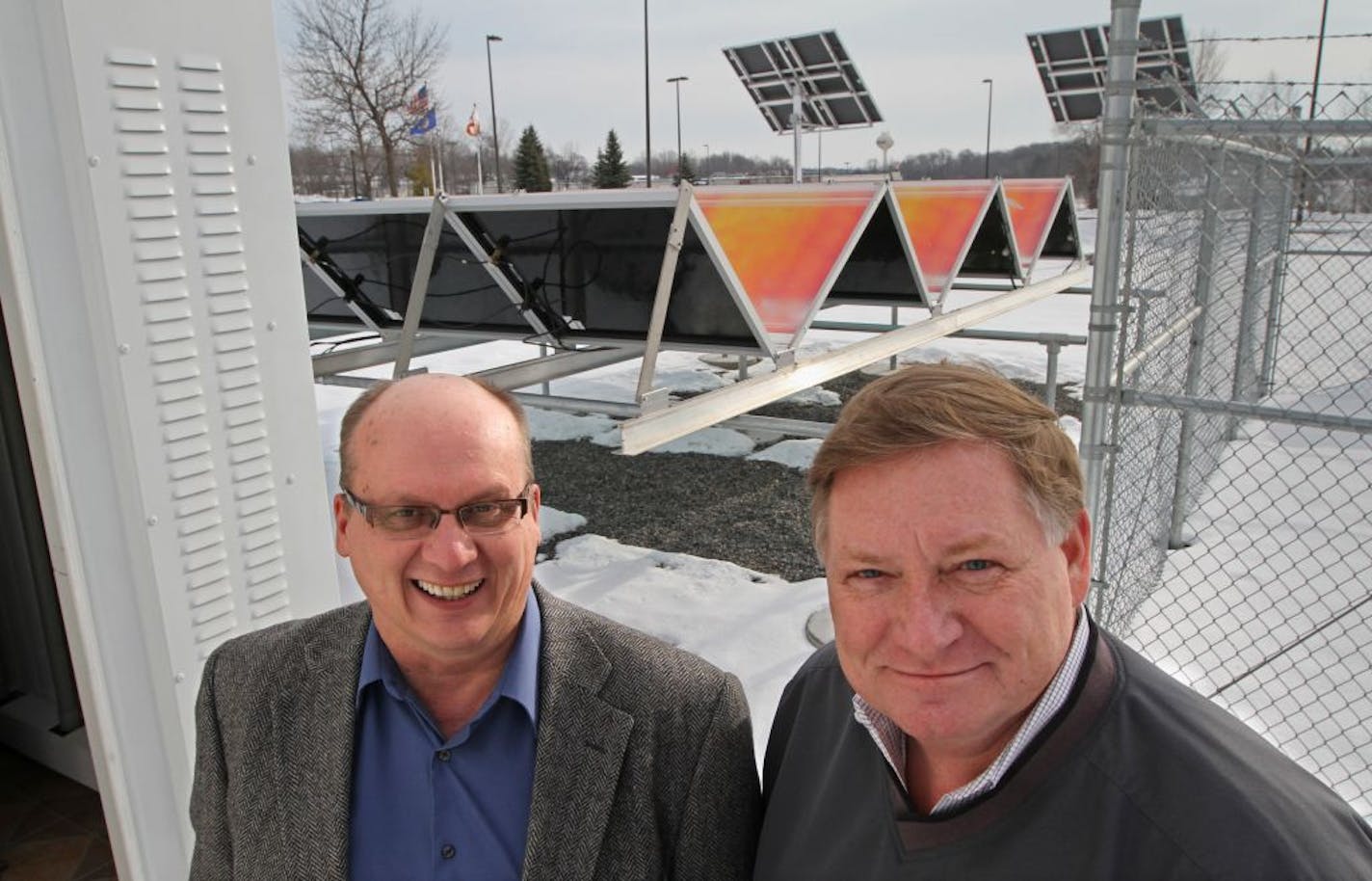 (left to right) Rod Nikula, COO of Wright-Hennepin Cooperative Electric and Mark Vogt, CEO were photographed on 1/8/13 with the test solar array at the Co-Ops building in Rockford MN.