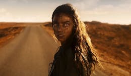 image of a woman in front of a dusty road