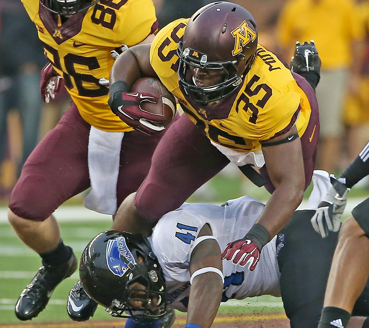 Minnesota running back Rodrick Williams Jr. ran passed Eastern Illinois safety Vince Speller during the second quarter in the opening game against Eastern Illinois at TCF Bank Stadium, Thursday, August 28, 2014 in Minneapolis, MN. ] (ELIZABETH FLORES/STAR TRIBUNE) ELIZABETH FLORES &#x2022; eflores@startribune.com