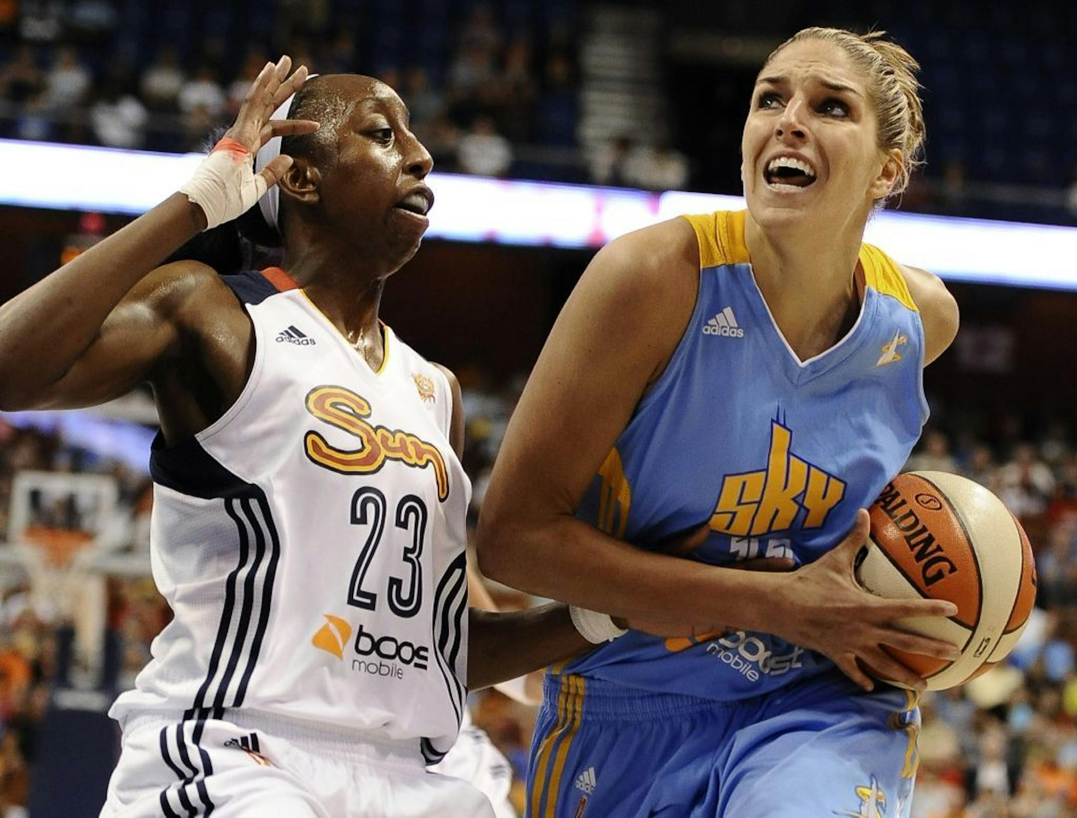 Chicago Sky's Elena Delle Donne, right, drives to the basket while being guarded by Connecticut Sun's Allison Hightower .
