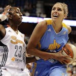 Chicago Sky's Elena Delle Donne, right, drives to the basket while being guarded by Connecticut Sun's Allison Hightower .