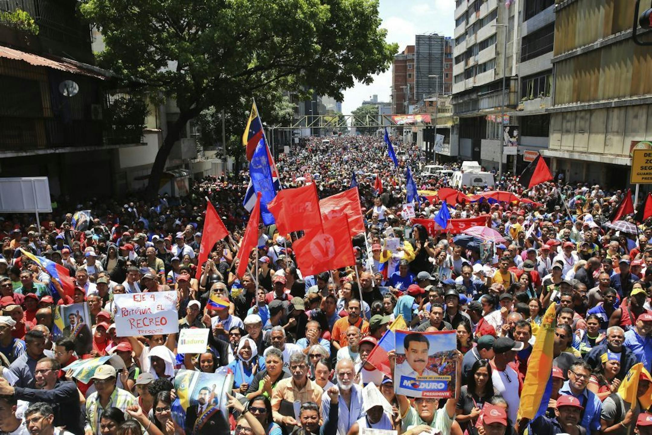 In this photo released by Miraflores presidential palace press office, supporters of President Nicolas Maduro gather outside Miraflores presidential palace, during an attempted military uprising against Maduro in Caracas, Venezuela, Tuesday, April 30, 2019. Amid the confusion, Maduro tried to project an image of strength, saying he had spoken to several regional military commanders who reaffirmed their loyalty to his socialist revolution.