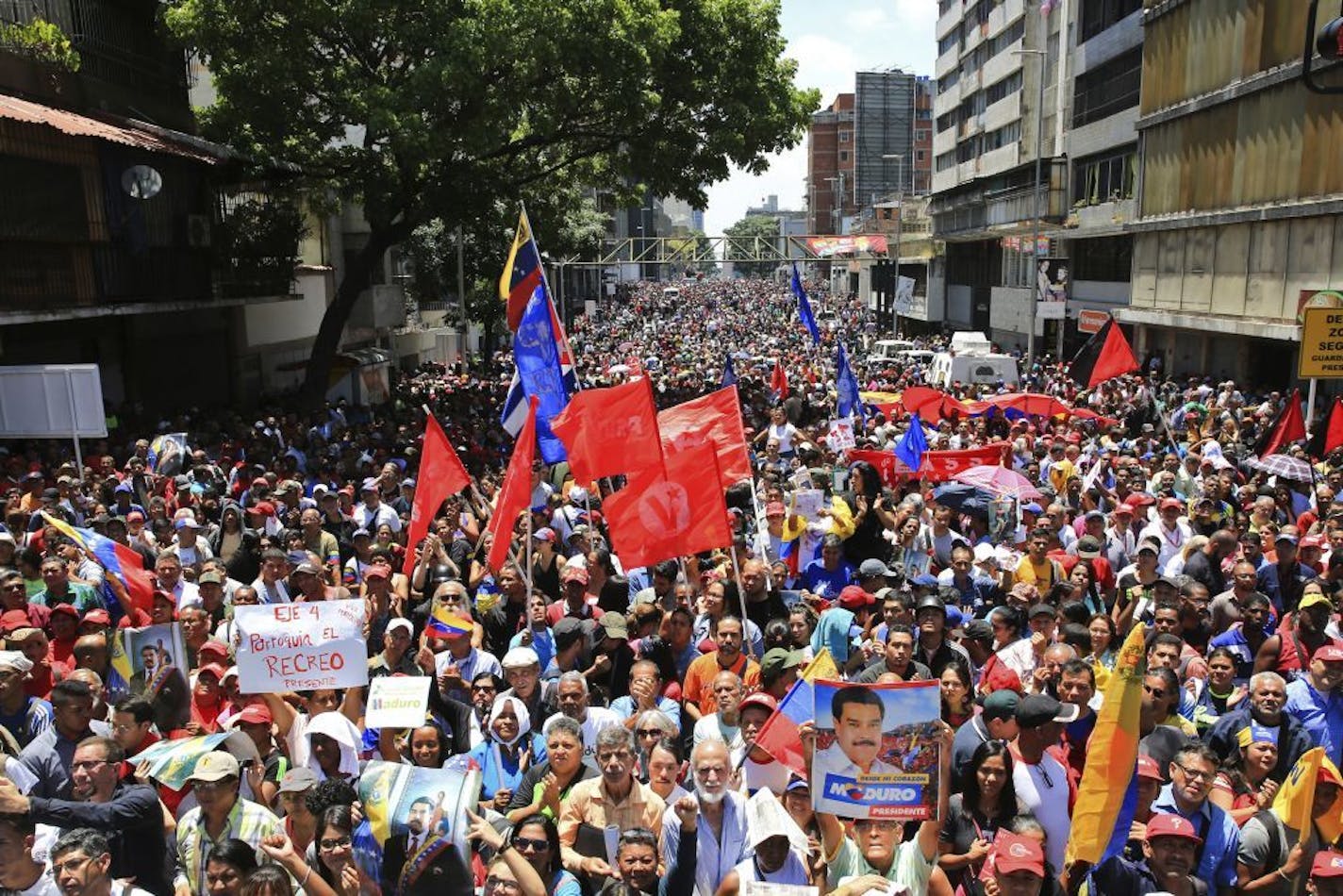 In this photo released by Miraflores presidential palace press office, supporters of President Nicolas Maduro gather outside Miraflores presidential palace, during an attempted military uprising against Maduro in Caracas, Venezuela, Tuesday, April 30, 2019. Amid the confusion, Maduro tried to project an image of strength, saying he had spoken to several regional military commanders who reaffirmed their loyalty to his socialist revolution.