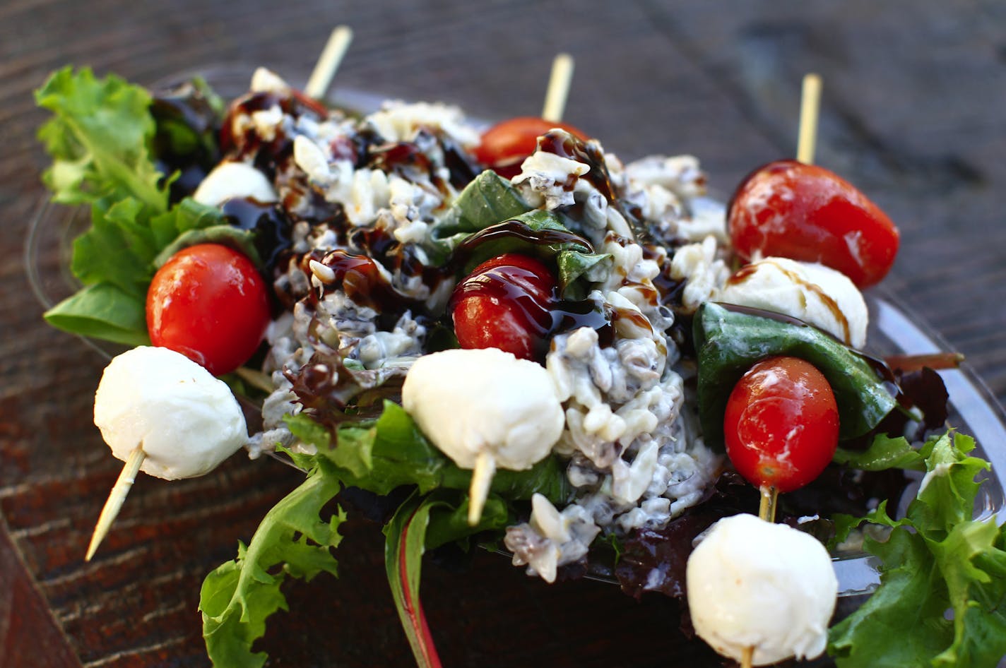 The Northwoods Salad on a Stick--three skewers of mozzarella, tomato and basil on a bed of wild rice salad and greens with balsamic glaze--is a healthy fair option available at Giggles' Campfire Grill at the Minnesota State Fair in St. Paul August 25, 2011. (Courtney Perry/Special to the Star Tribune)