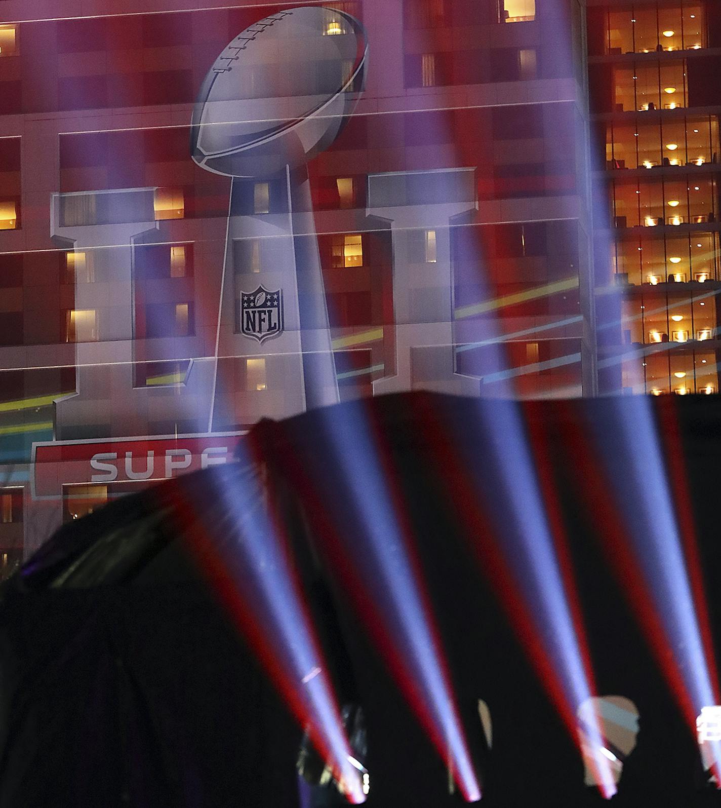 A image of the Lombardi Trophy is projected on the side of a building during Super Bowl Live in Discovery Green park on Thursday, Feb. 2, 2017, in Houston. (Curtis Compton/Atlanta Journal-Constitution via AP) /Atlanta Journal-Constitution via AP)