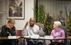 Inmate LaVon Johnson talked during the book club discussion as guests Barbara Strandell, left, and Dennie Scott listened.