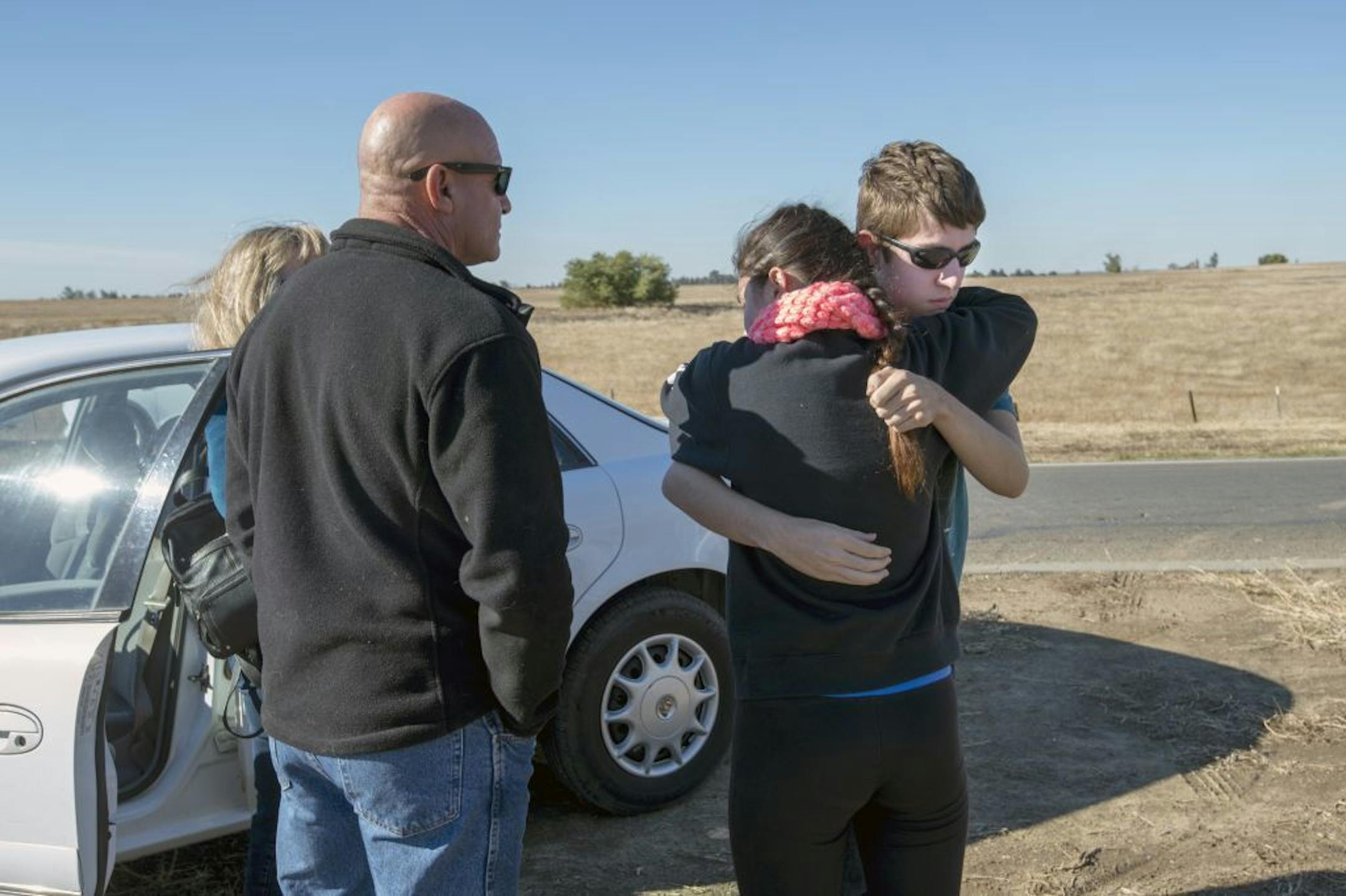 University of California, Merced student Justin Dick, right, hugs his sister Kristen as his parents Beth and Keith look on following a stabbing in Merced, Calif., Wednesday, Nov. 4, 2015. An assailant stabbed five people at the rural university campus in central California before police shot and killed him, authorities said Wednesday. Justin was one of 15 students in the core class where the incident took place Wednesday morning. (Paul Kitagaki Jr.(Paul Kitagaki Jr./The Sacramento Bee via AP) MA