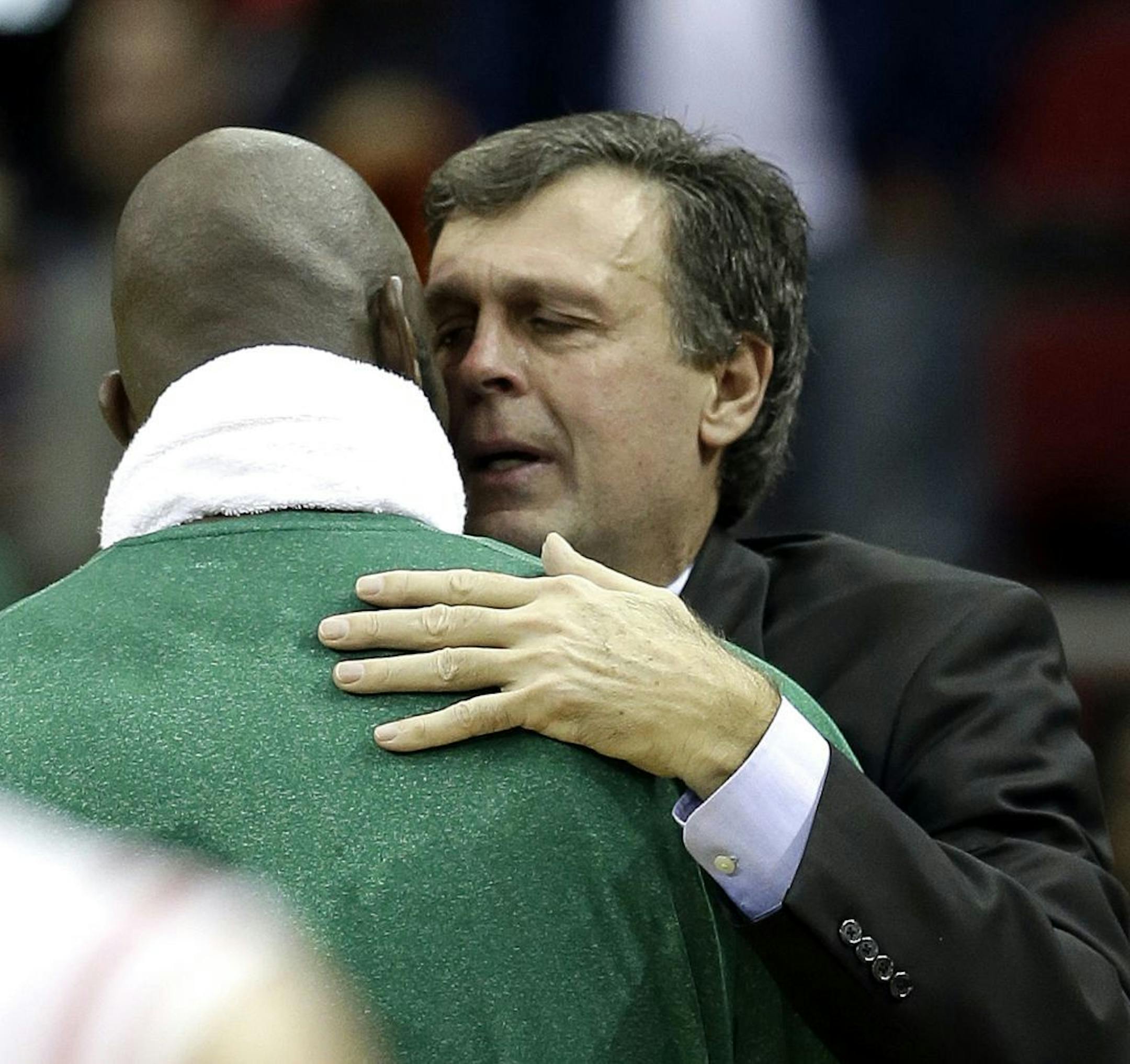 Houston Rockets coach Kevin McHale, right, is hugged by Boston Celtics' Kevin Garnett after an NBA basketball game Friday, Dec. 14, 2012, in Houston. McHale's daughter died recently. The Rockets beat the Celtics 101-89.