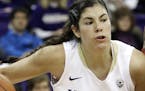 FILE - In this Jan. 17, 2016, file photo, Washington guard Kelsey Plum, left, drives around Southern California forward Temi Fagbenle, second from lef