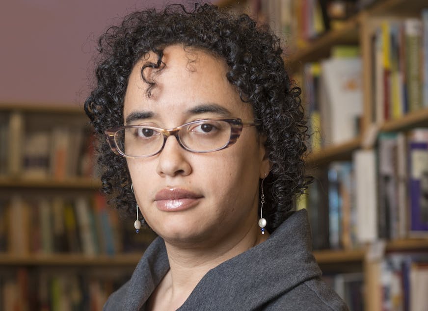 photo of author Shannon Gibney, with bookshelves in the background