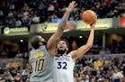 Karl-Anthony Towns shoots against the Pacers' Kyle O'Quinn