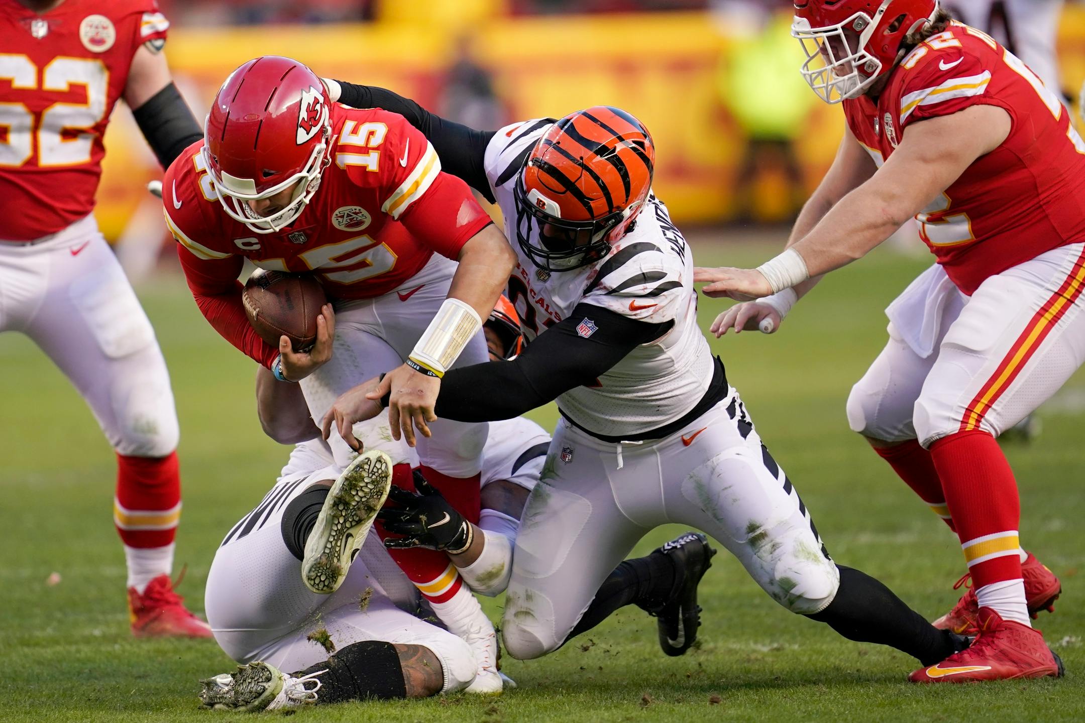 Kansas City Chiefs quarterback Patrick Mahomes (15) is sacked by Cincinnati Bengals defensive end Trey Hendrickson, right, during the second half of the AFC championship NFL football game, Sunday, Jan. 30, 2022, in Kansas City, Mo. (AP Photo/Paul Sancya)
