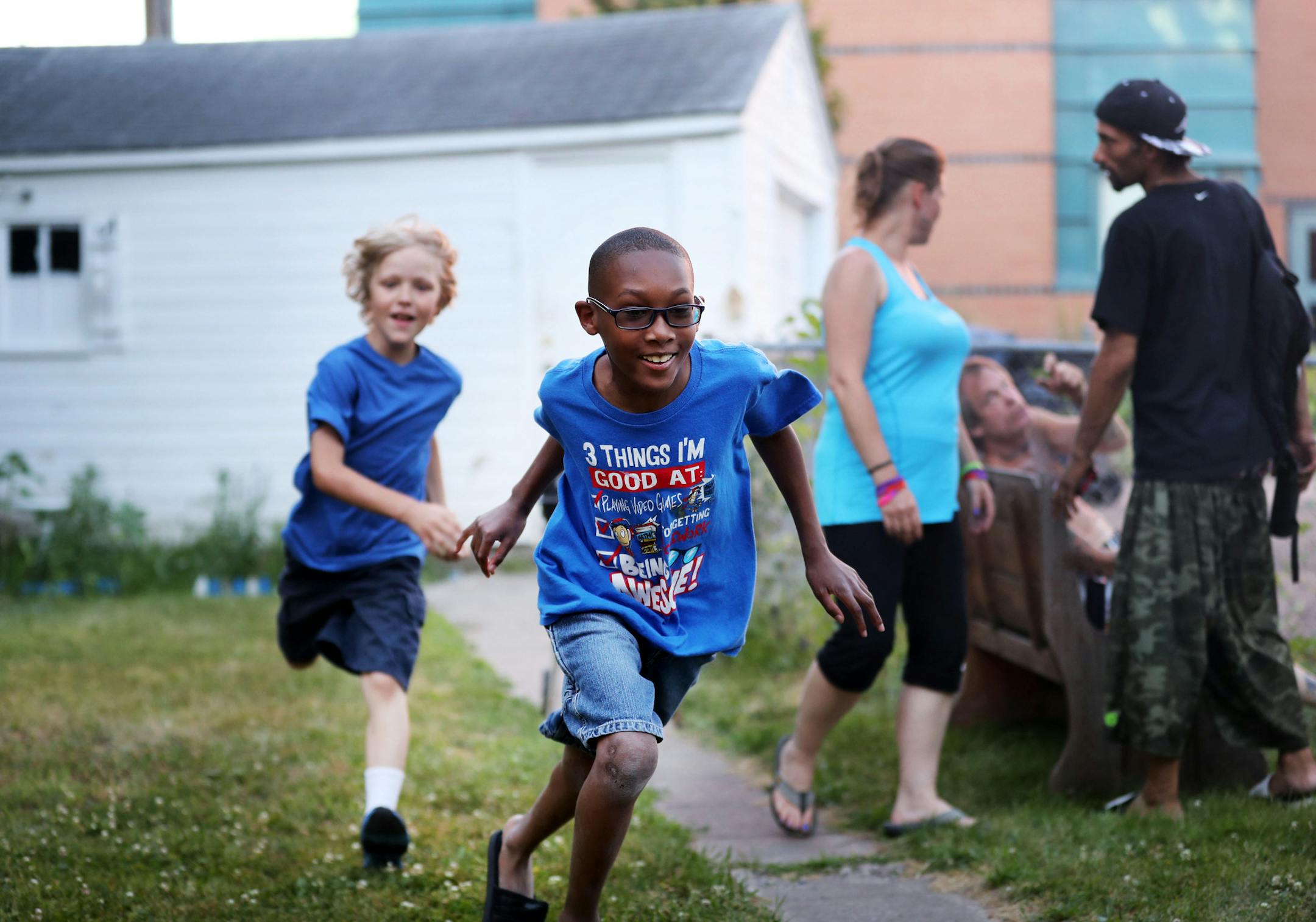 Josh Barker, front, a fifth grader who loves to play, and is the only child remaining who lived on the block when 3-year-old Terrell Mayes was shot, plays with neighbor Jacob Van Sickle, left. Van Sickle was recently assaulted by kids who tried to steal his bike. ìFor me itís just dangerous,î Van Sickle, 8, said. ìI got jumped. I got slapped. People tried to steal my bike.î] The boys were seen playing Sunday, July 3, 2016, in Minneapolis, MN.](DAVID JOLES/STARTRIBUNE)djo