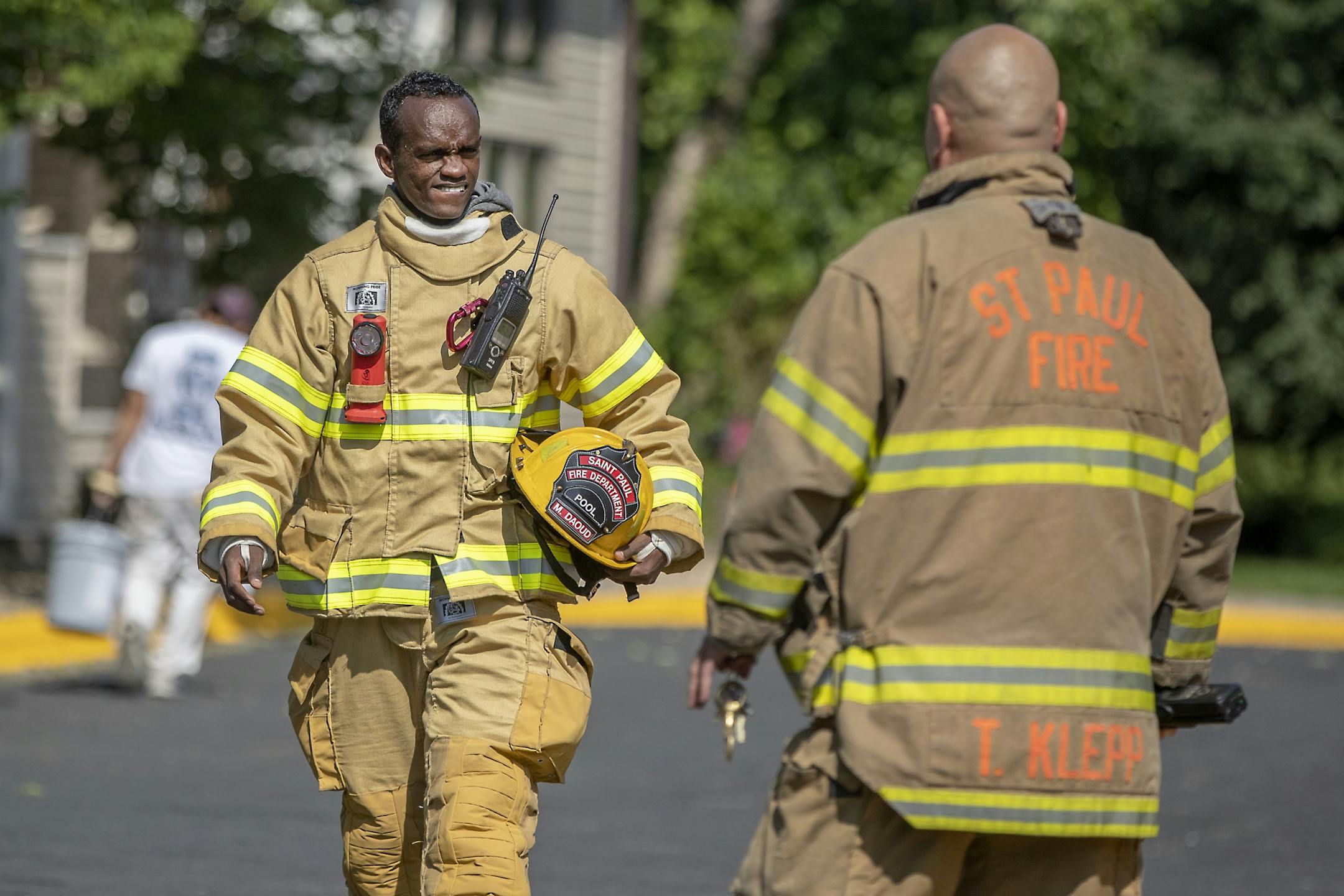 St. Paul firefighter Mohamed Daoud made his way out of a false alarm in an apartment complex along with Captain Tomo Klepp, cq, of Station 23 during his second day on the job as one of the first Somali Americans to be sworn into the St. Paul fire department.