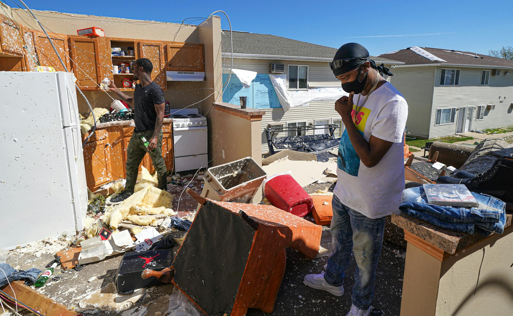 Andre Moren, right, and his cousin Dennis Muhammad looked over what was left of their belongings from their second floor apartment. When the storm hit, they hunkered down next to the half wall in the background while the derecho passed, taking away most of the walls and roof of their home. ] GLEN STUBBE • glen.stubbe@startribune.com Tuesday, August 18, 2020 Derecho storm devastation in Cedar Rapids Iowa, with 130,000 residents the state's second-largest city. The "inland hurricane" last week wip