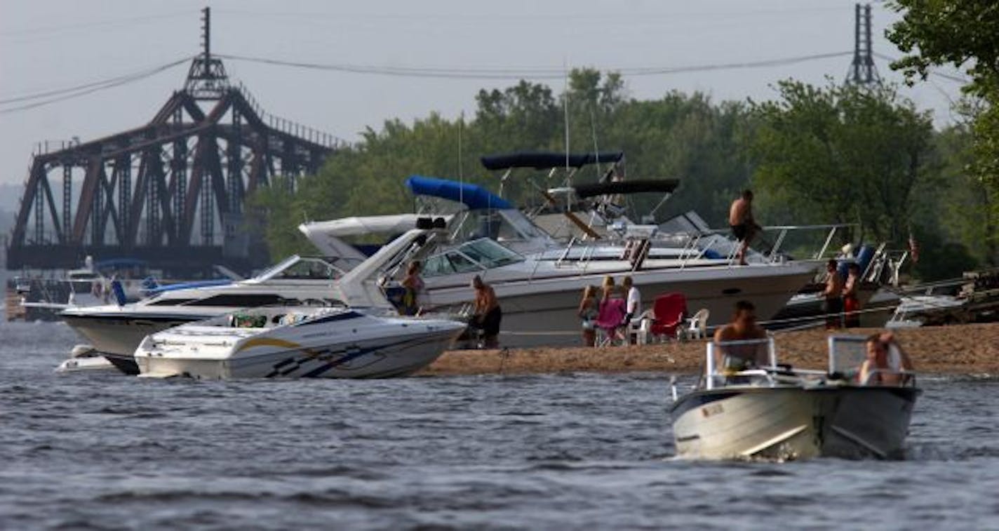 Still worth a visit, for now: Boaters established camp on a site nicknamed "Beer Can Island" across from Hudson, Wis. "A lot of people live ecologically on the river," said Nature Center Director Jim Fitzpatrick. "But there's plenty of finger-pointing to go around."