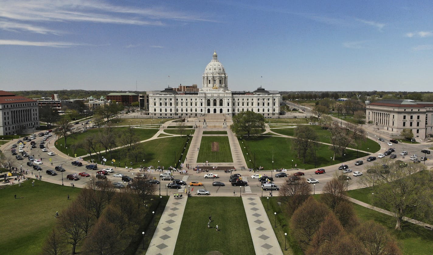 Vehicles circled the Minnesota State Capitol, covered with flags and signs, during Saturday's protest against Gov. Tim Walz's "Stay Home MN" executive orders meant to slow the spread of COVID-19 ] aaron.lavinsky@startribune.com Protesters organized by the Minnesota Gun Rights advocacy group staged a drive-by protest calling for an end to Gov. Tim Walz's "Stay Home MN" executive orders meant to slow the spread of COVID-19 Saturday, May 2, 2020 at the State Capitol in St. Paul, Minn.