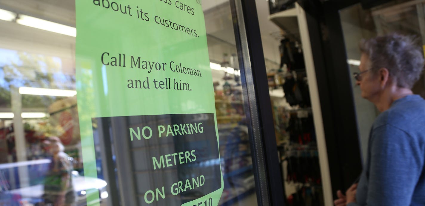 A customer walked into Frattelone Ace Hardware passed a sign that asked for support of no parking meters along Grand Ave. ] (KYNDELL HARKNESS/STAR TRIBUNE) kyndell.harkness@startribune.com On Grand Avenue in St Paul Min., Thursday October 1, 2015. St. Paul's plan to test metered parking on Grand Avenue, the city's best known commercial strip, has merchants and businesses seeing red. The council is expected to approve the measure in mid-October. ORG XMIT: MIN1510011719062041