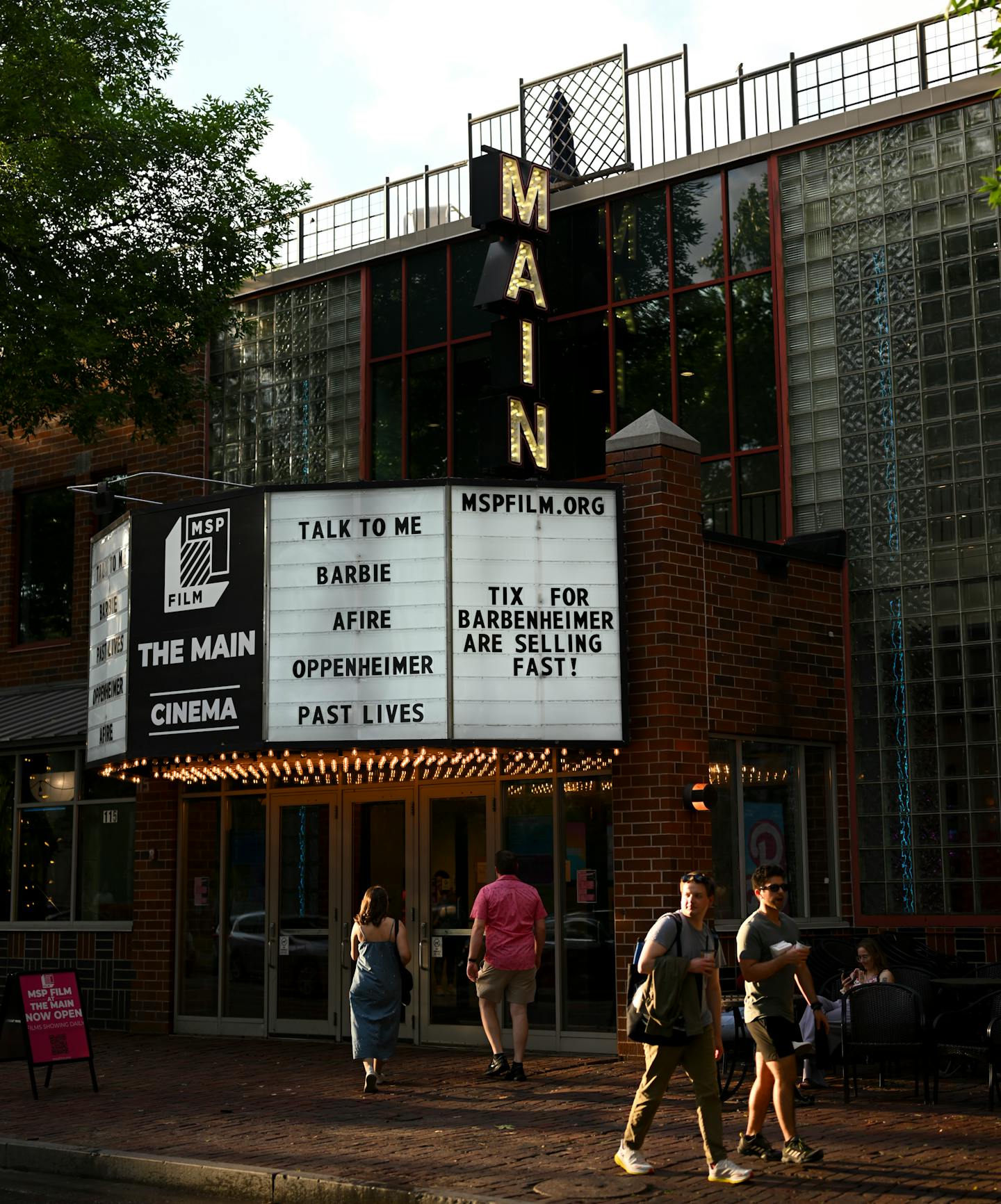 People walk past the marquee Friday, July 28, 2023 outside the Main Cinema in Minneapolis, Minn.. The blockbuster releases of Oppenheimer and Barbie could show the demand for movie theaters isn't dead due to streaming services and the pandemic. ] AARON LAVINSKY • aaron.lavinsky@startribune.com