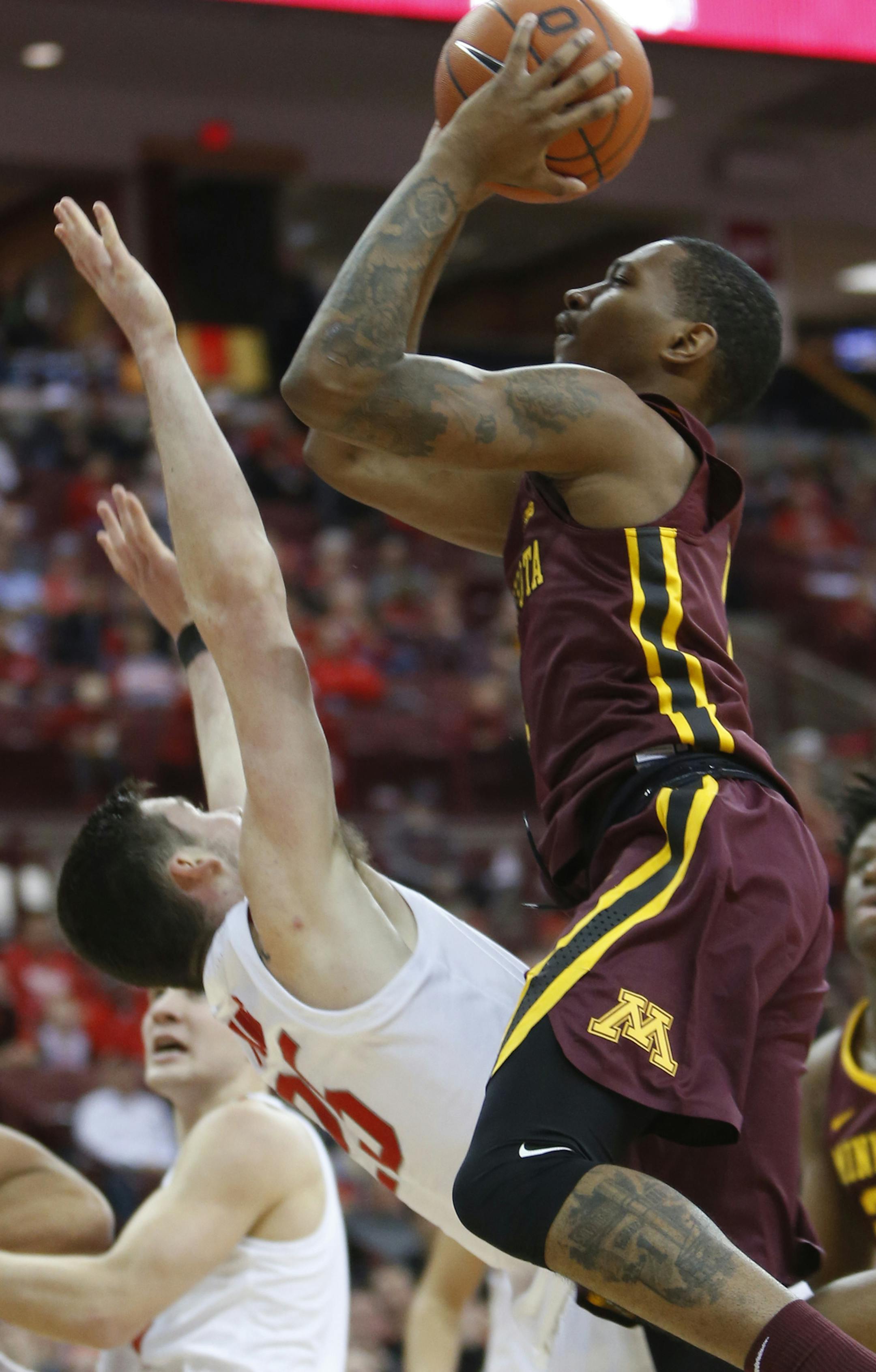 Minnesota's Dupree McBrayer, right, charges Ohio State's Kyle Young during the first half of an NCAA college basketball game Sunday, Dec. 2, 2018, in Columbus, Ohio. (AP Photo/Jay LaPrete)