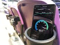 Samsung's S10 5G phone sits in a cupholder at U.S. Bank Stadium as a speed test is displayed on the screen. The phone downloaded data at the rate of 8
