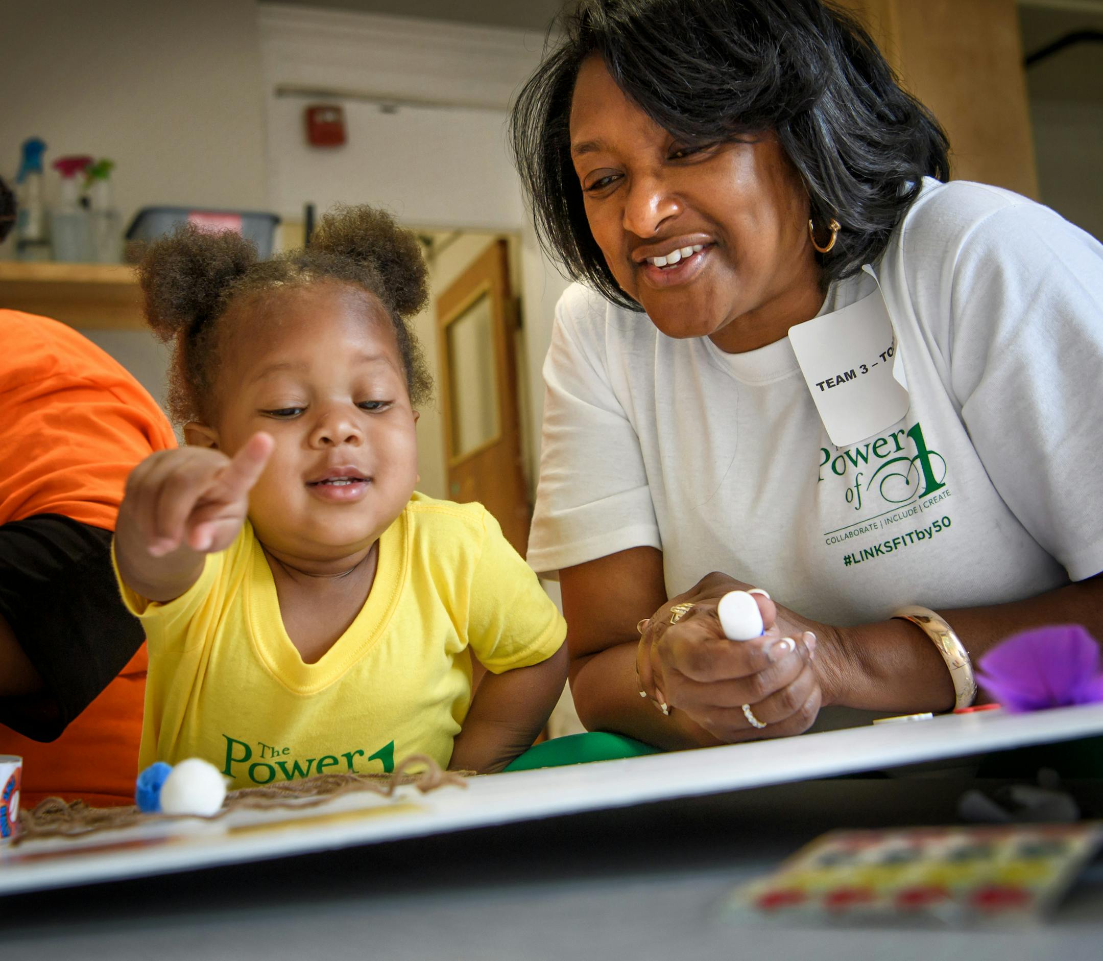 Links volunteer Karen Patricia Williams, right, used glue, stickers, feathers and magazine photos to help Tamijai Long construct a Mood Board to show what is special about her, in her mind, her heart and in her tummy at Agape Childhood Development Center. ] GLEN STUBBE • glen.stubbe@startribune.com Tuesday June 6, 2017 800 African American women descend on the Twin Cities for service projects. 100 Links members worked on a service project at Agape Childhood Development Center in North Min