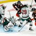 Minnesota Wild goaltender Cam Talbot, bottom left, stops a shot by the Anaheim Ducks during the second period of an NHL hockey game Monday, Jan. 18, 2