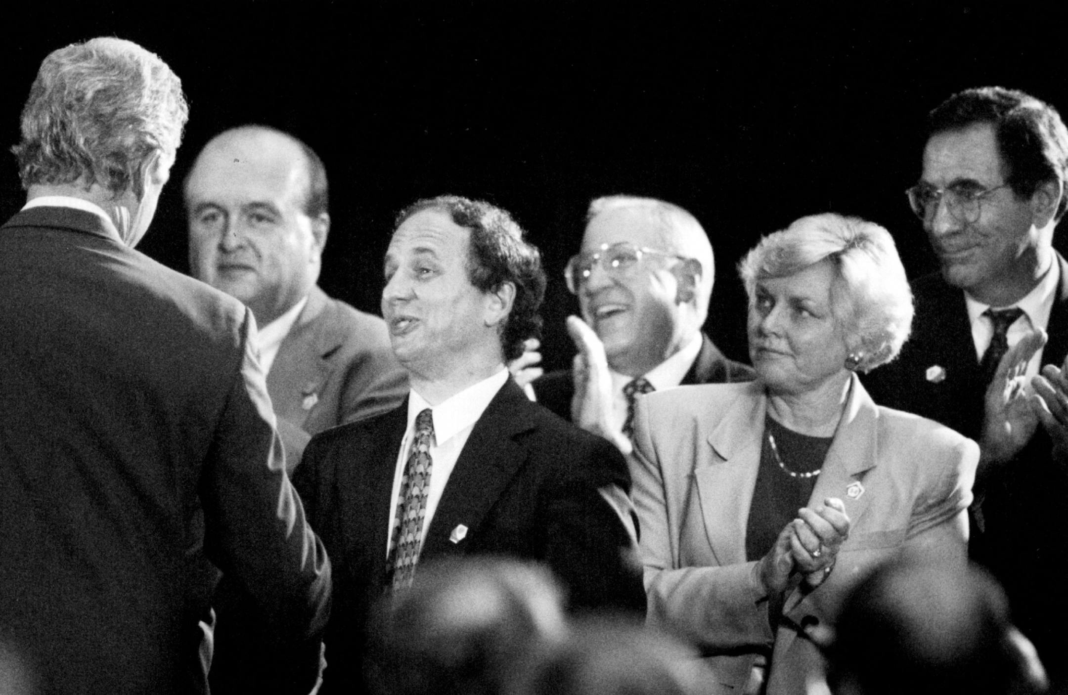 August 12, 1994: President Clinton shook hands with (left to right) Dennis Flaherty (Exec Director of the Minnesota chapter of the National Assoc. of Police Organizations), Sen. Paul Wellstone, Skip Humphry, Joanell Dyrstad and Bruce Vento as he worked the audience after his speech.