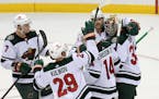 Minnesota Wild goaltender Cam Talbot, right, celebrates with teammates after the Wild defeated the New Jersey Devils 3-2 in a shootout during an NHL h
