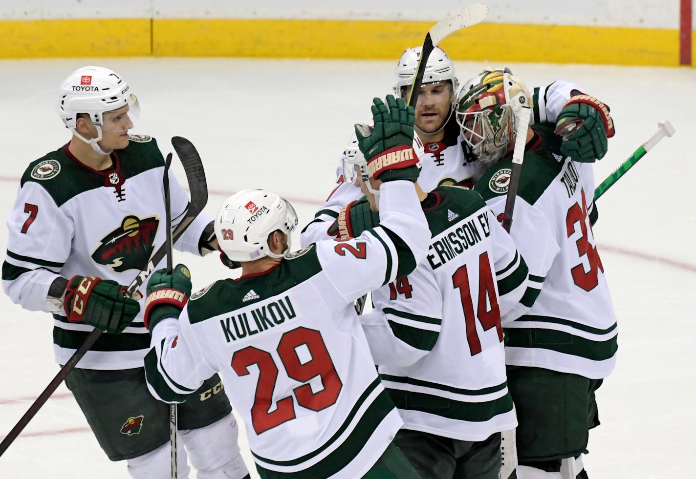 Minnesota Wild goaltender Cam Talbot, right, celebrates with teammates after the Wild defeated the New Jersey Devils 3-2 in a shootout during an NHL hockey game Wednesday, Nov.24, 2021, in Newark, N.J. (AP Photo/Bill Kostroun)