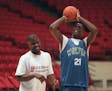 Wolves rookie Kevin Garnett shoots after practice with JR Rider at the Target Center in 1995.