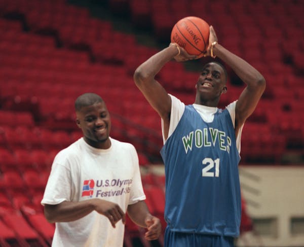 Wolves rookie Kevin Garnett shoots after practice with JR Rider at the Target Center in 1995.