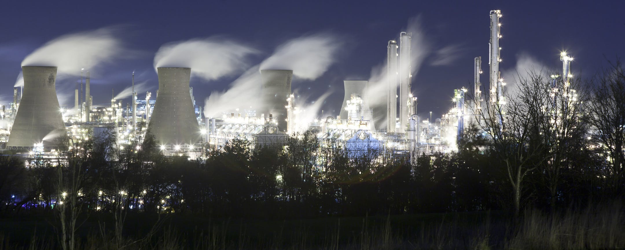A refinery complex lights up the night sky in Grangemouth, Scotland, Nov. 19, 2013. Ineos, the Swiss firm that owns much of the site, shuttered parts of it during a labor dispute, an incident that highlighted Scotland's uncomfortable reliance on the oil sector and the country's uncertain economic future ahead of an upcoming referendum on independence. (Robert Ormerod/The New York Times)