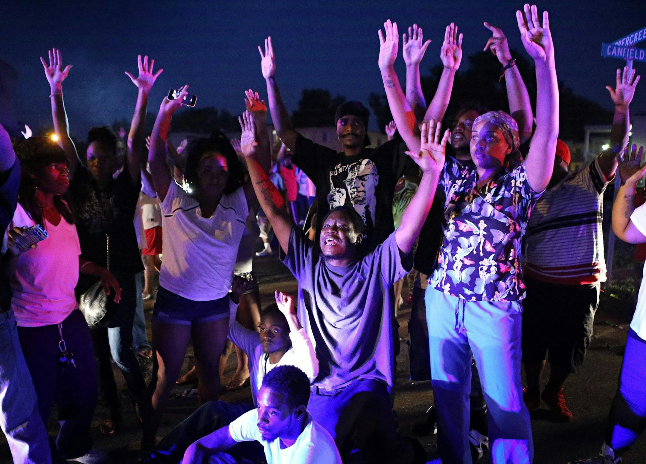 "Don't shoot us" cries out the crowd as they confront police officers arriving to break up a crowd in Ferguson, Mo., on Saturday, Aug. 9, 2014. Earlier in the day police had shot and killed an 18-year-old man. (David Carson/St. Louis Post-Dispatch/MCT) ORG XMIT: 1155949
