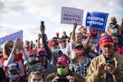 Trump supporters craned their necks as they tried to get a look at the runway in Bemidji on Friday as they awaited the president's arrival.