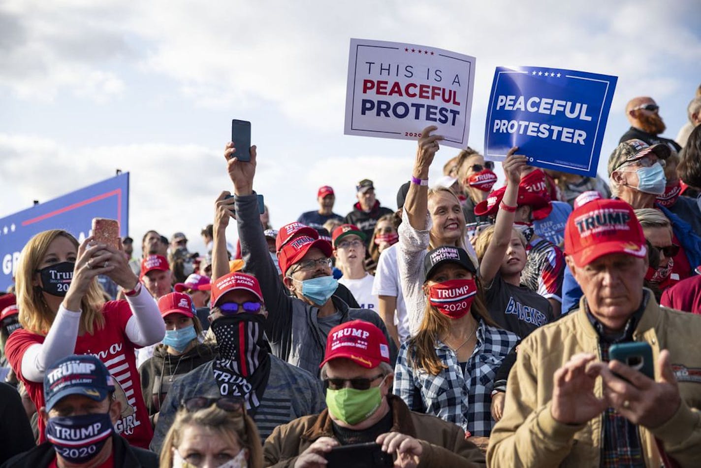 Trump supporters craned their necks as they tried to get a look at the runway in Bemidji on Friday as they awaited the president's arrival.