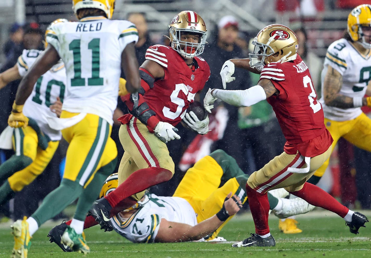 San Francisco 49ers' Dre Greenlaw returns an interception of a Green Bay Packers pass in the final minute.