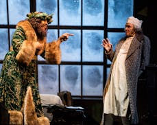 Ansa Akyea as the Ghost of Christmas Present and Nathaniel Fuller as Ebenezer Scrooge in "A Christmas Carol" at the Guthrie Theater.